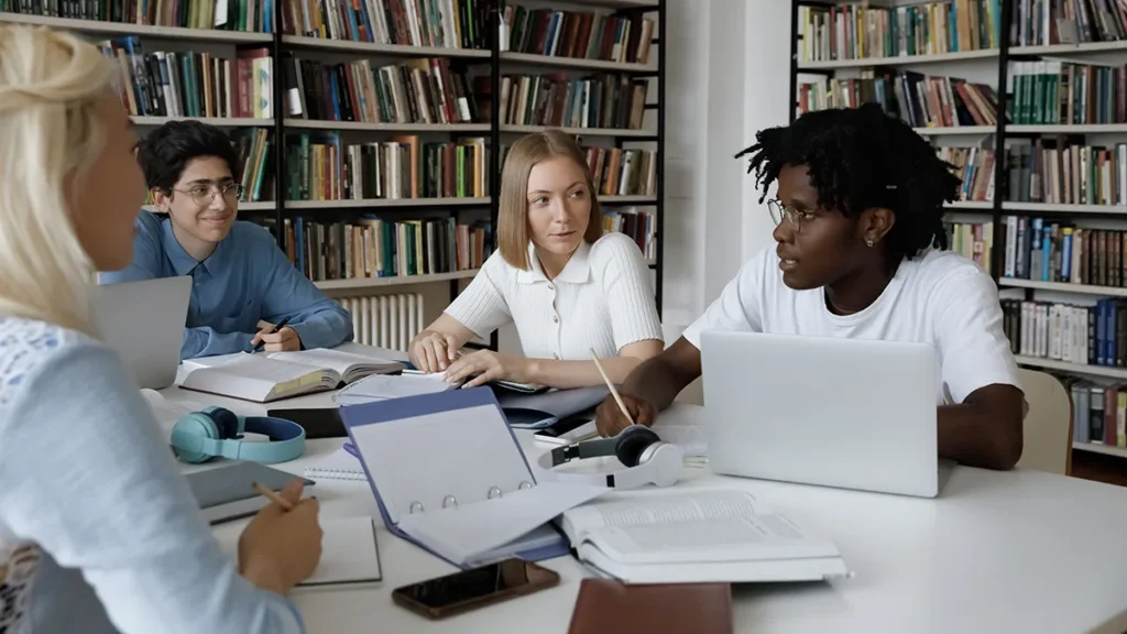 Students discussing the humanities in a library